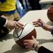 A basketball is signed before the basketball banquet on Tuesday, April 16. AnnArbor.com I Daniel Brenner